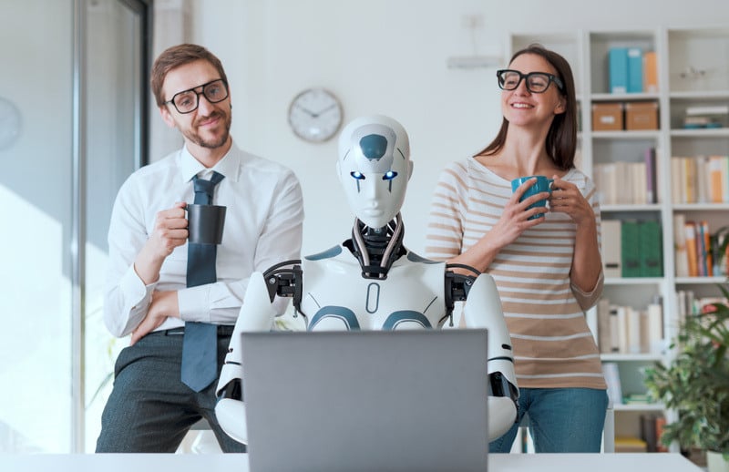 Workers happily sit back and relax as a robot takes over their computer tasks