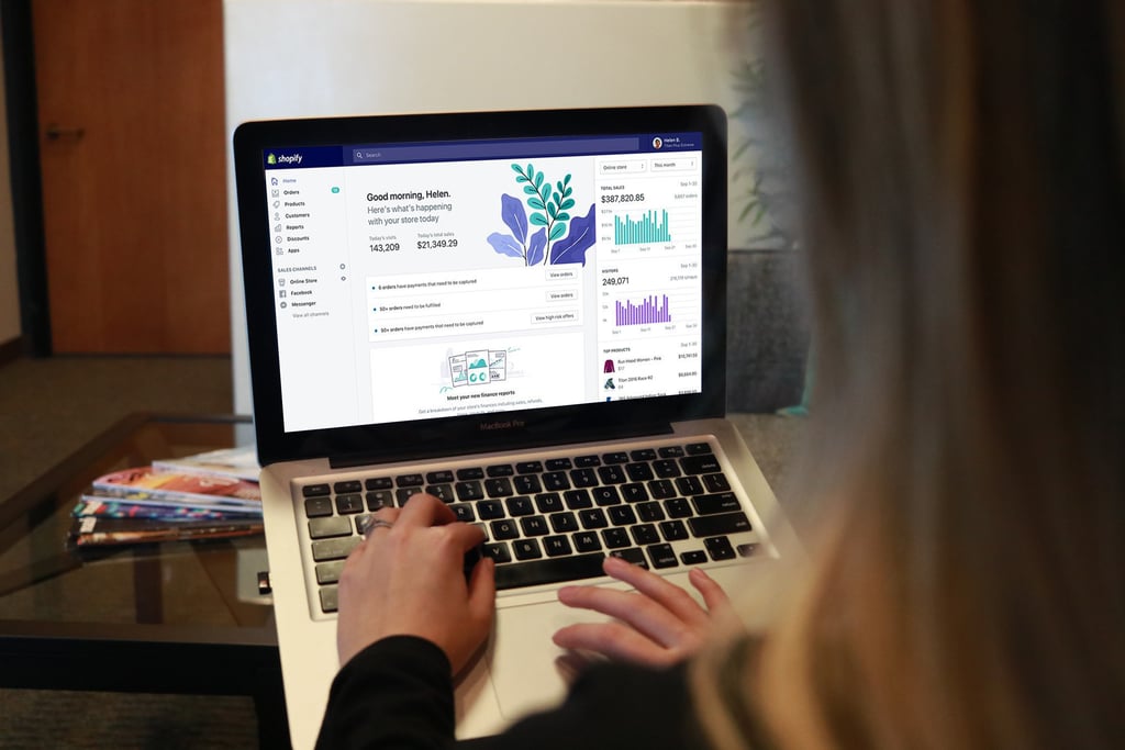 Girl on laptop looking at Shopify platform