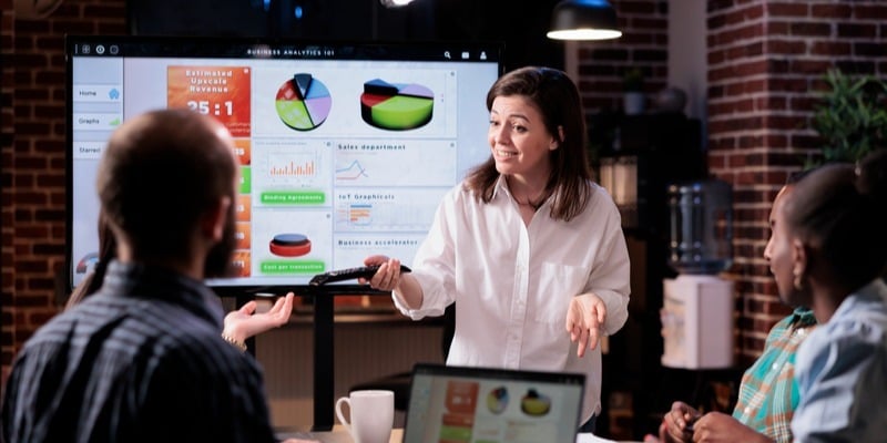 Woman at a startup trains her team on new software